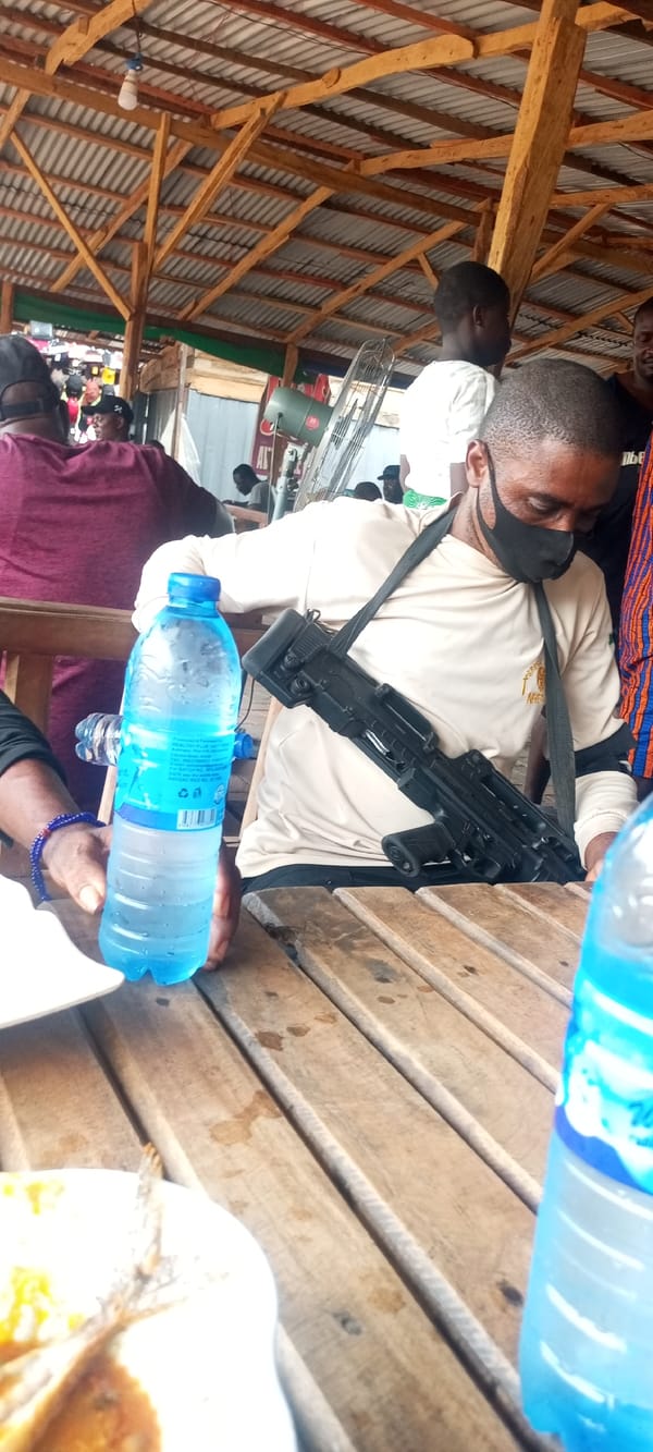 Man enjoys fish meal at Nigerian open-air restaurant