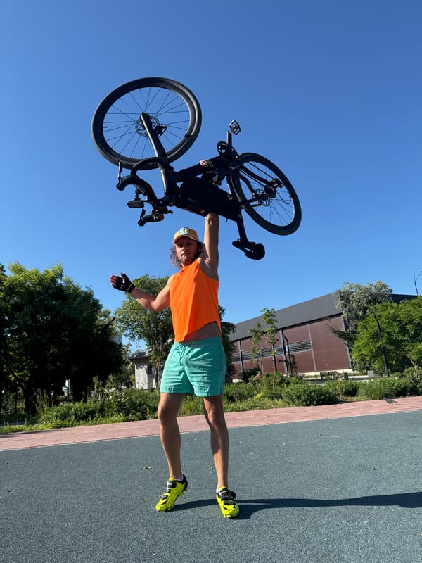 Man holds bicycle overhead in Ukrainian coastal town