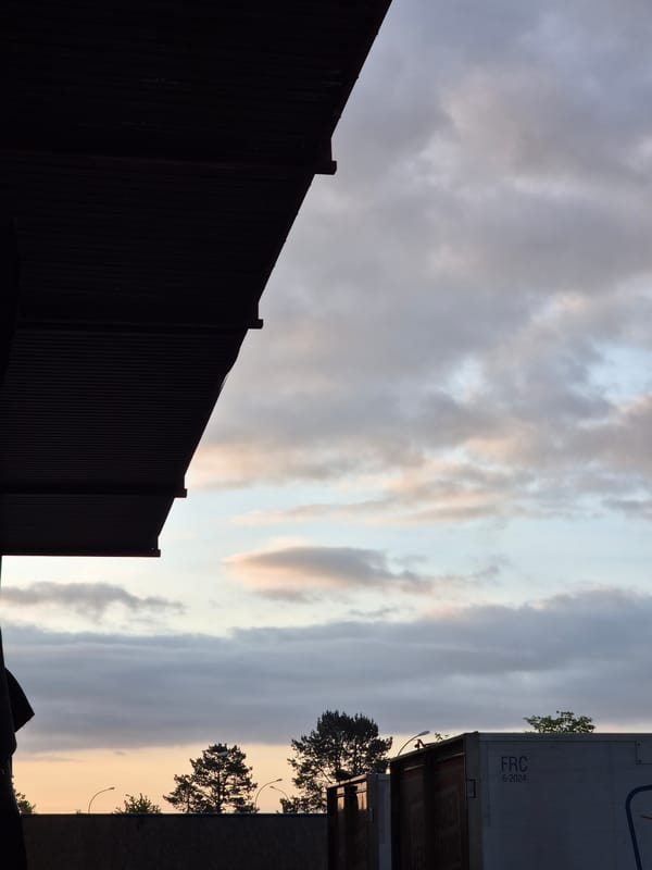 Dawn sky and commercial district observed in Leudelange