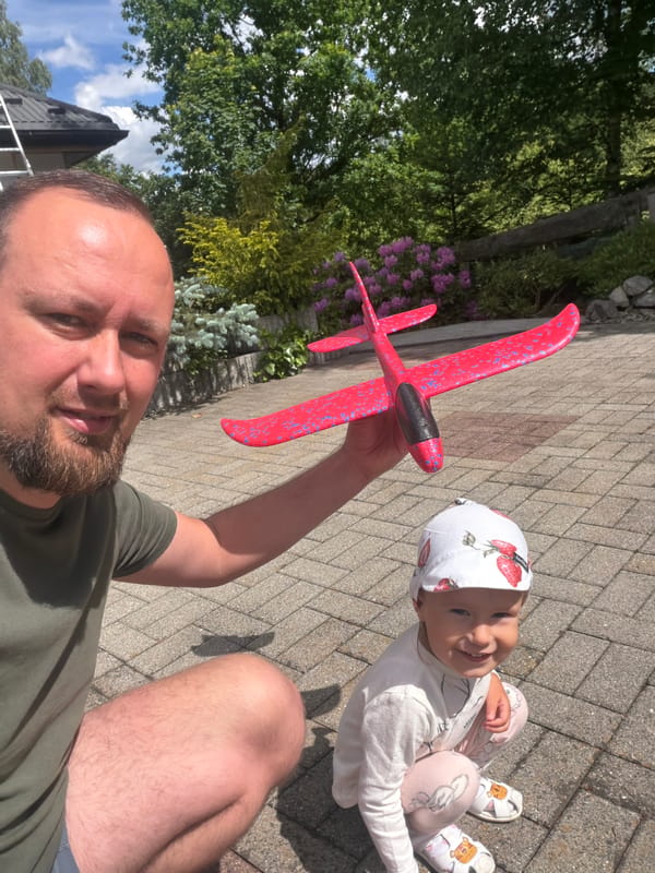 Father and child enjoy outdoor playtime in Wisła, Poland