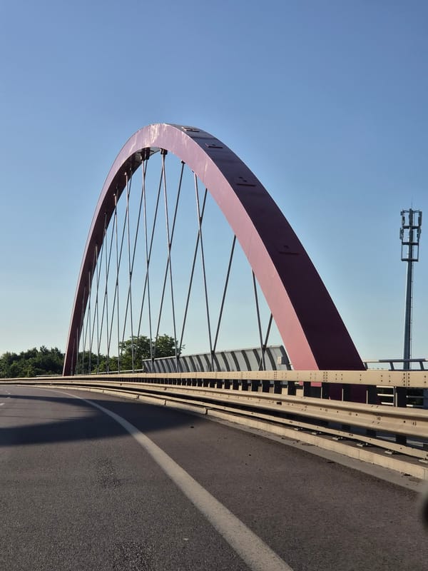 Clear skies frame Pont Rouge bridge in Schifflange