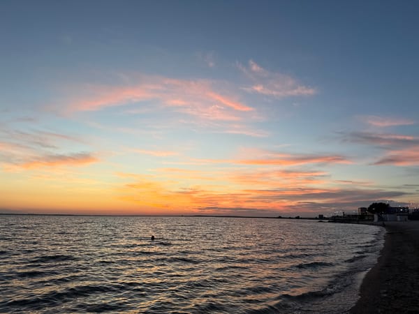 Quiet sunset over a still shoreline in Kokshetau