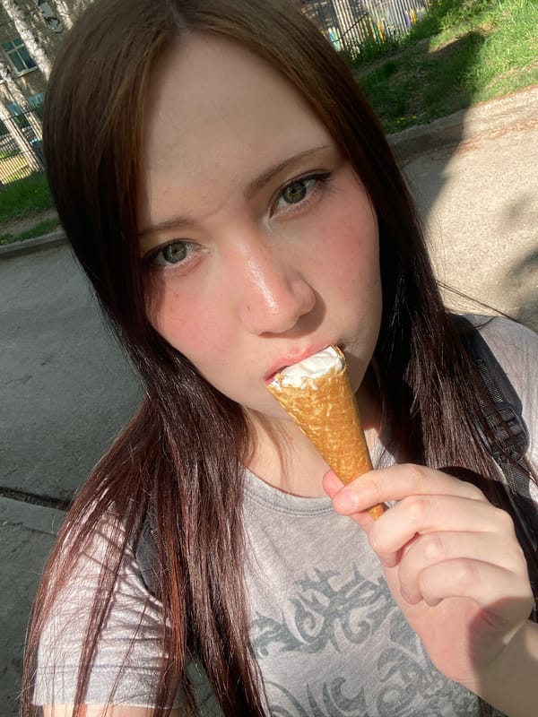 Woman enjoys ice cream, handles photos during morning outing