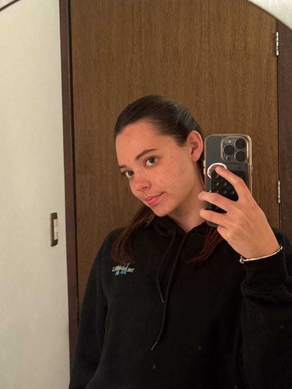 Woman takes mirror selfie in Mexican town early morning