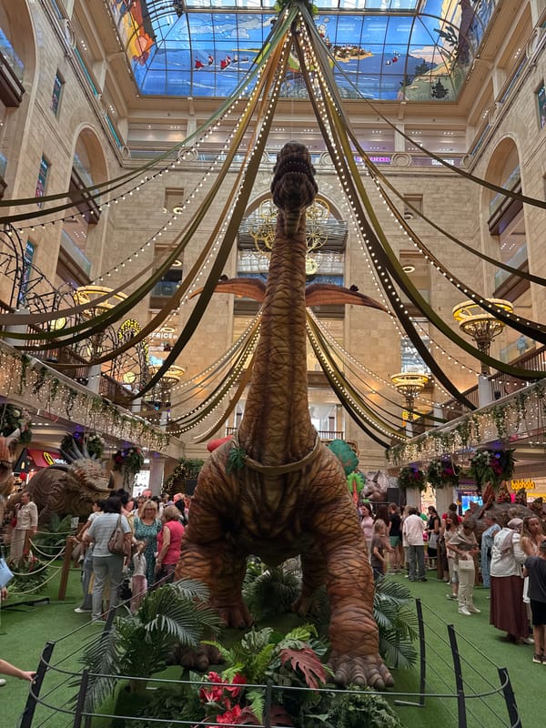 Indoor dinosaur exhibit at a mall, plus Moscow street scenes