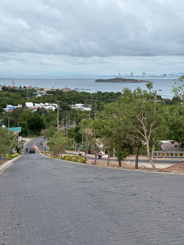 Road view captures Pattaya coastline and skyline scene