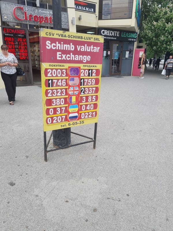 Street-level city scenes: trolleybus, currency exchange, and wet crosswalks
