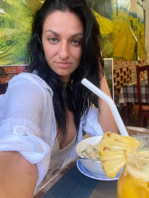 Two friends enjoy leisurely restaurant meal in Vietnam