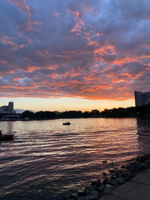 Minsk sunset paints the Svislach River and streets in vivid color