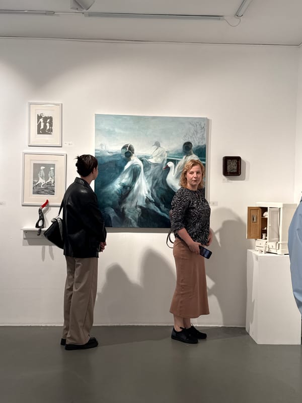 Inside a contemporary art exhibition, paintings and sculptures on show