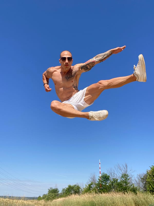 Tattooed acrobat mid-flip in Pleven, Bulgaria