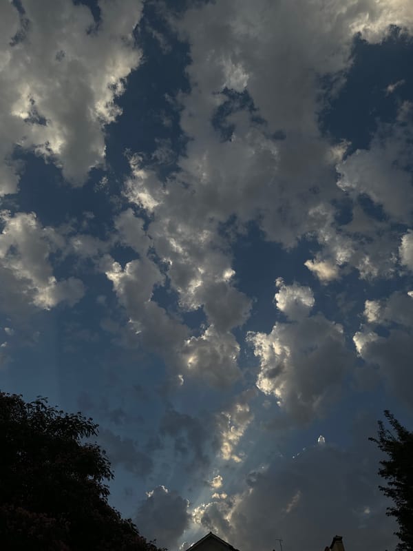 Sunlit cumulus clouds and crepuscular rays over Tashkent
