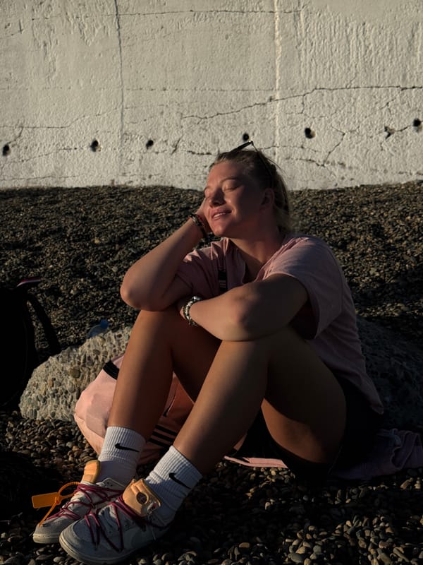 Woman on Sochi beach, dental grills found on rocks