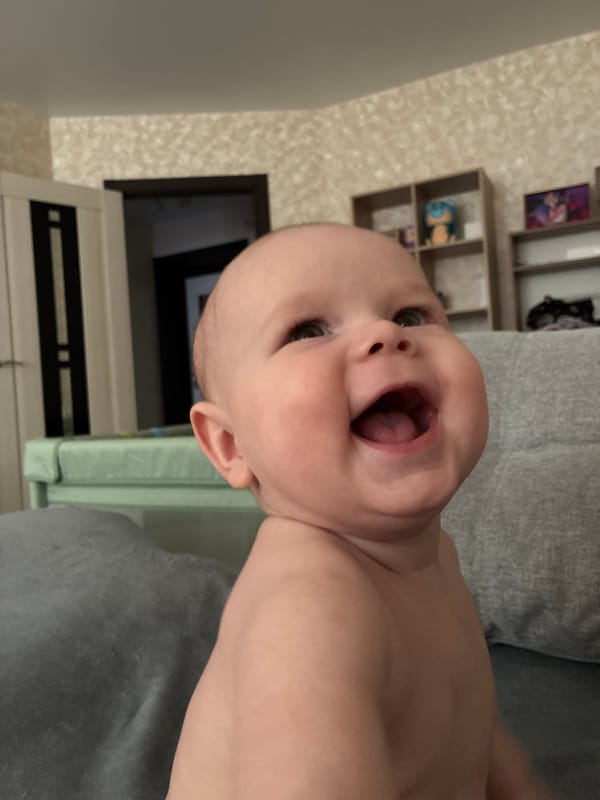 Baby moments and tablet gaming, with a Tver cityscape overhead