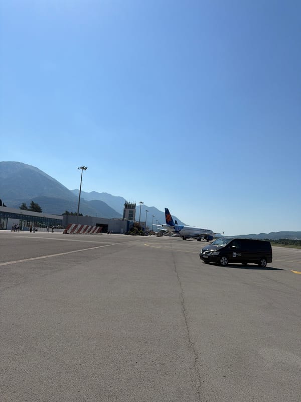Departure day: tarmac, water views, and a yacht outside