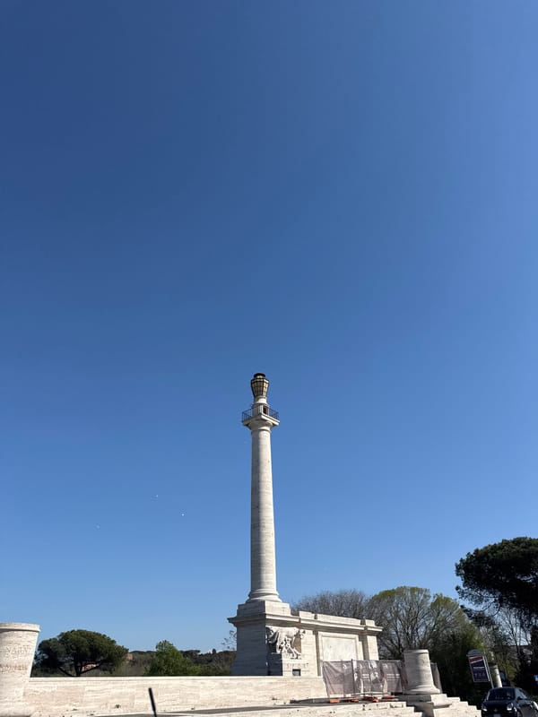Tourist photographs historic Marcus Aurelius Column in Rome
