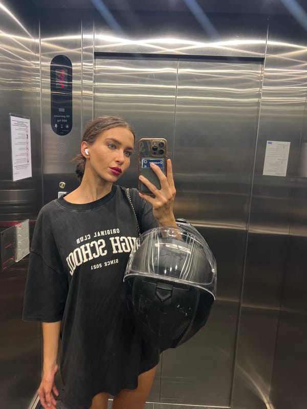 Woman takes selfies with motorcycle helmet in Wichit building