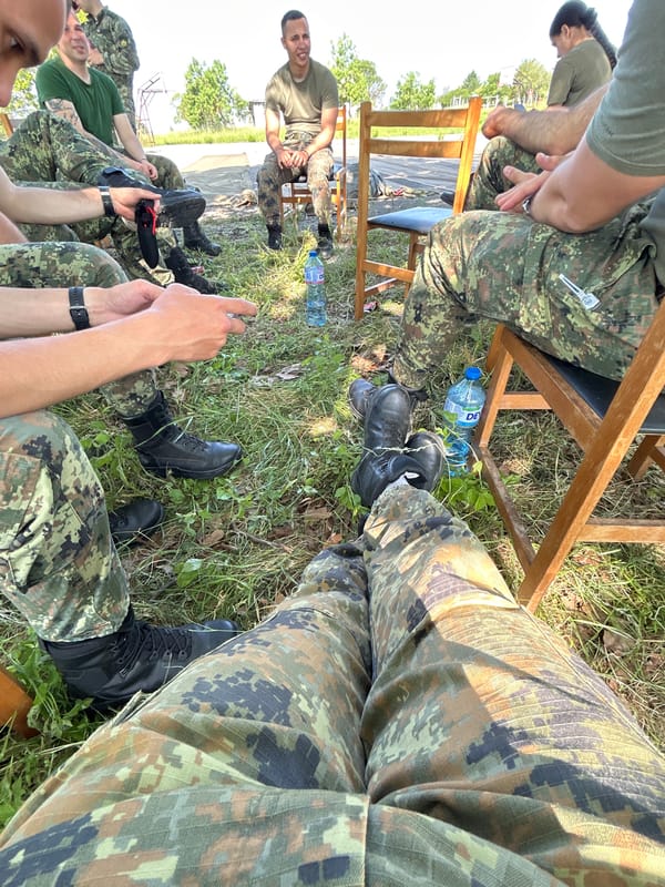 Military-dressed group gathers at outdoor facility in Bulgaria