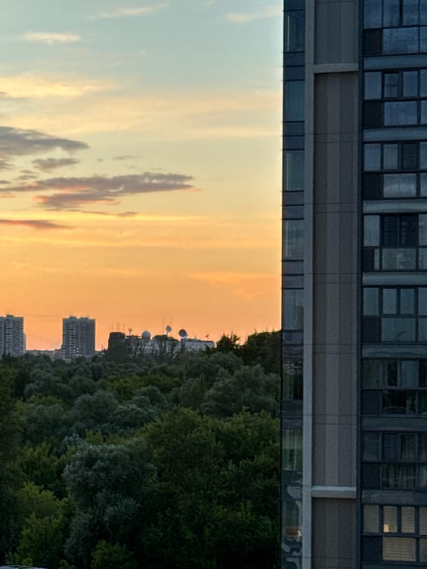 City skyline at golden hour, clouds and reflections
