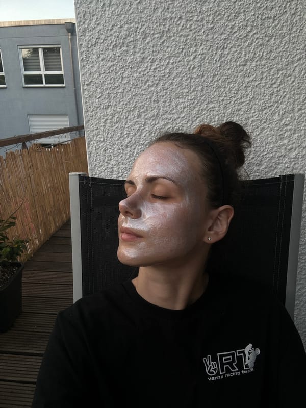 Woman relaxes with facial mask in lounge chair