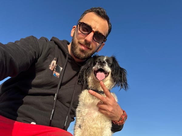 Visitor photographs coastal scenes with dog in Tsarevo, Bulgaria