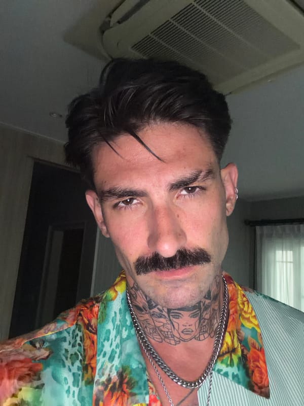 Man grooms facial hair while being filmed in Chalong bathroom