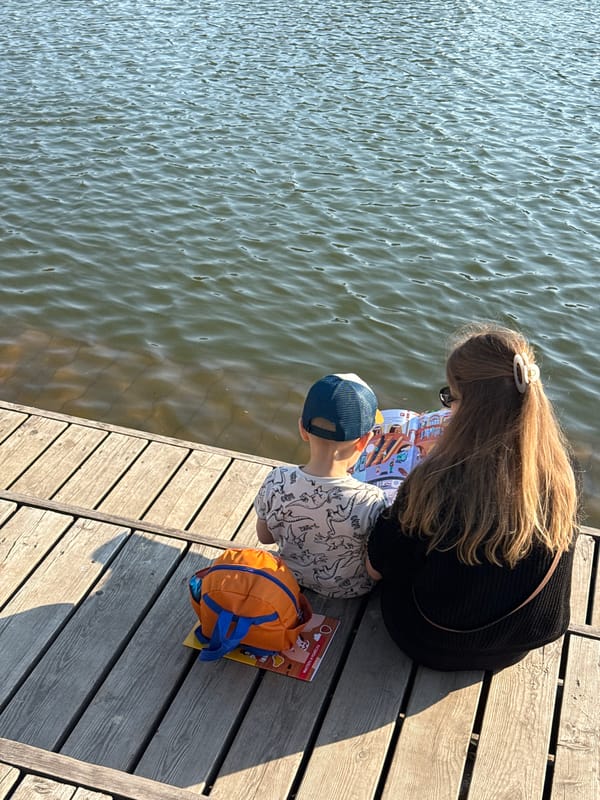 Woman and child enjoy afternoon at Dmitrov waterfront dock