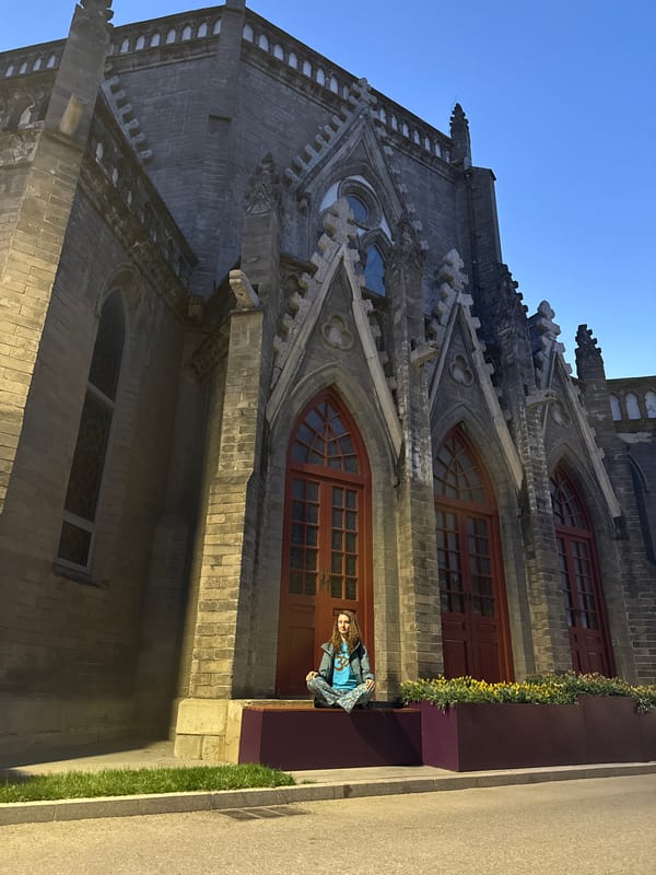 Woman sits outside historic Xishiku Cathedral in Beijing
