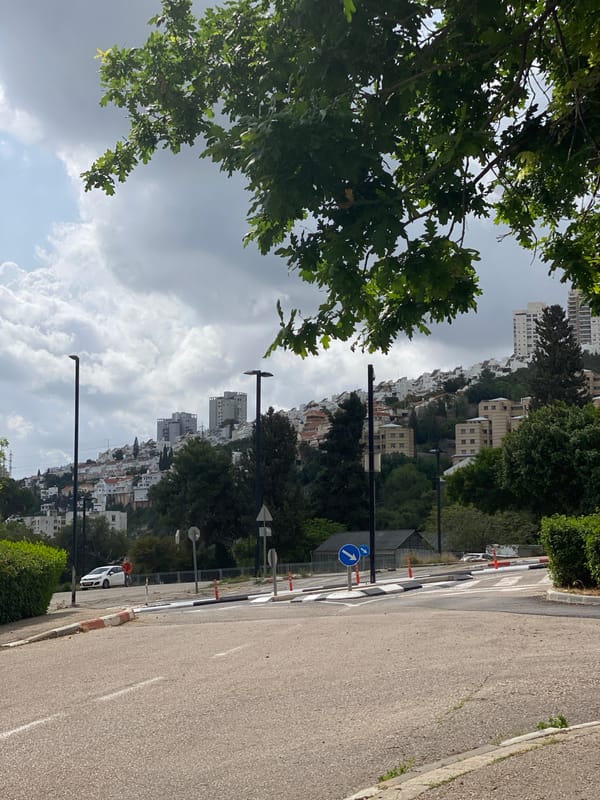 Morning street scene captured on downhill road in Haifa