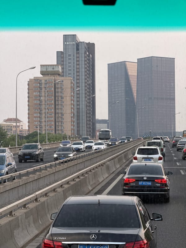 Beijing traffic crawls under orange morning sky across districts