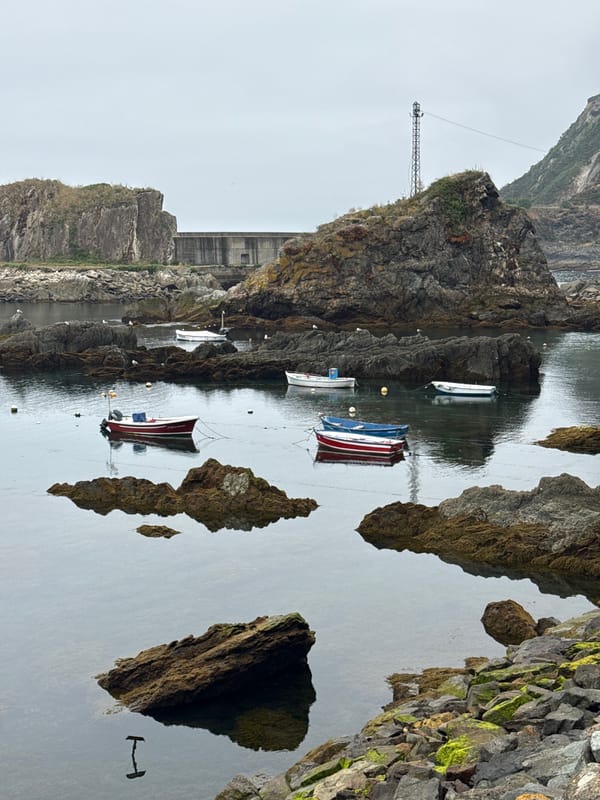 Cudillero's harbor, tunnels, and waterfall on a quiet morning