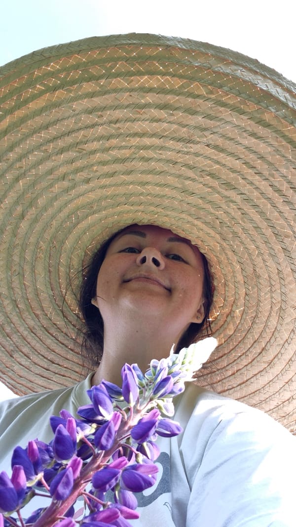 Person enjoys quiet morning with flowers, radio in Russian town
