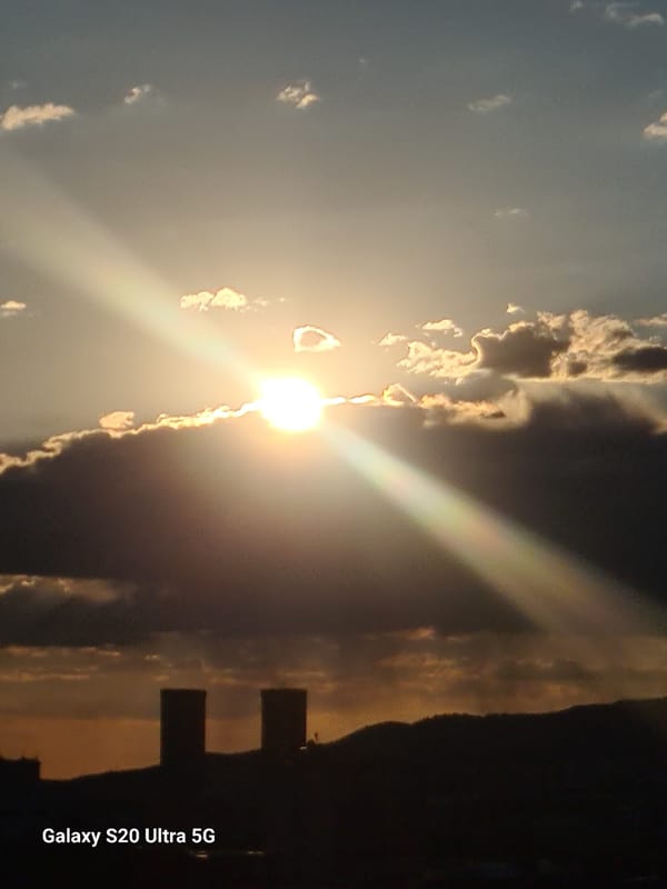 Dramatic cloud-filtered sunset lights up the Almaty skyline