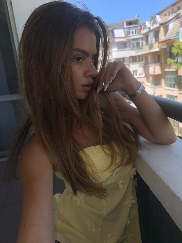 Balcony selfie session in a yellow floral dress, Plovdiv