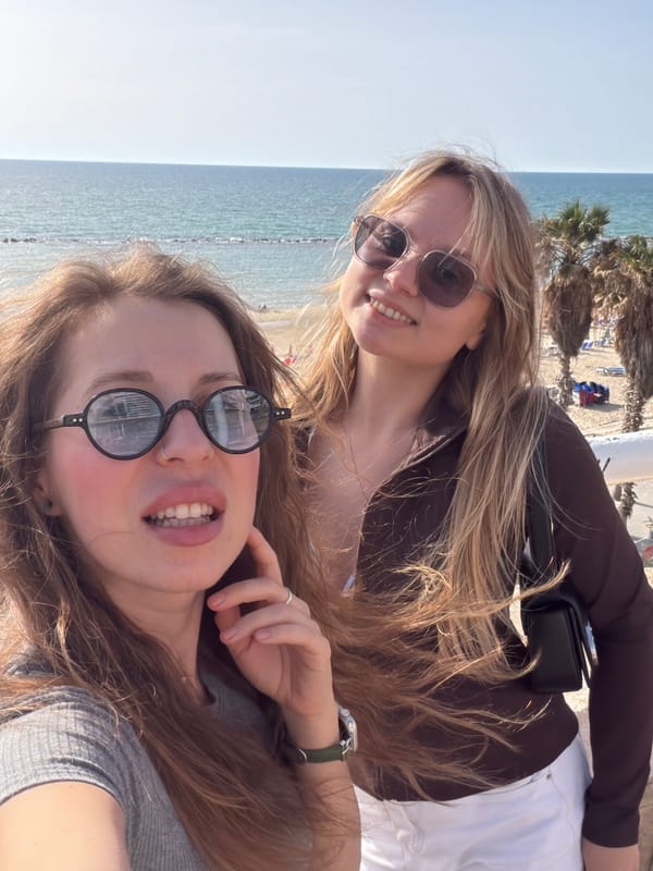 Women take beachside selfies on Bat Yam balcony