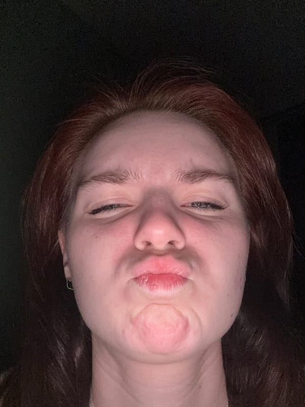 Person takes selfie with puckered lips expression