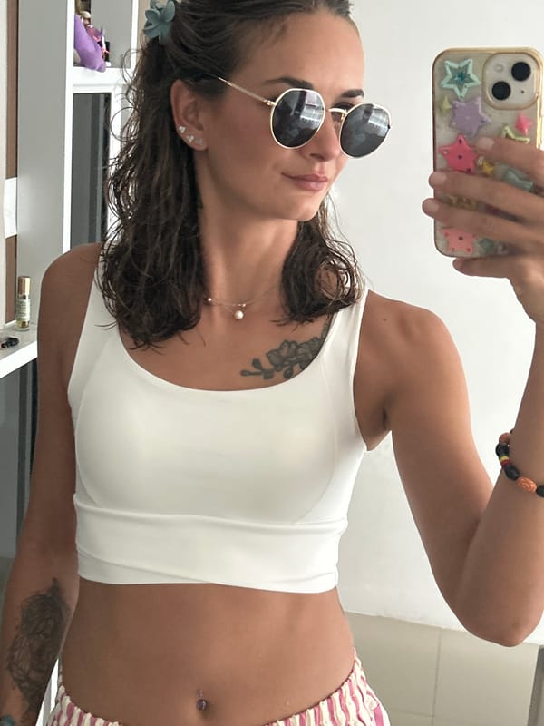 Woman takes mirror selfie indoors in Kathu, Thailand