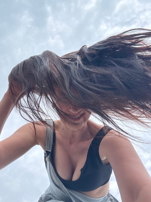 Woman documents beach visit in Sochi under cloudy skies