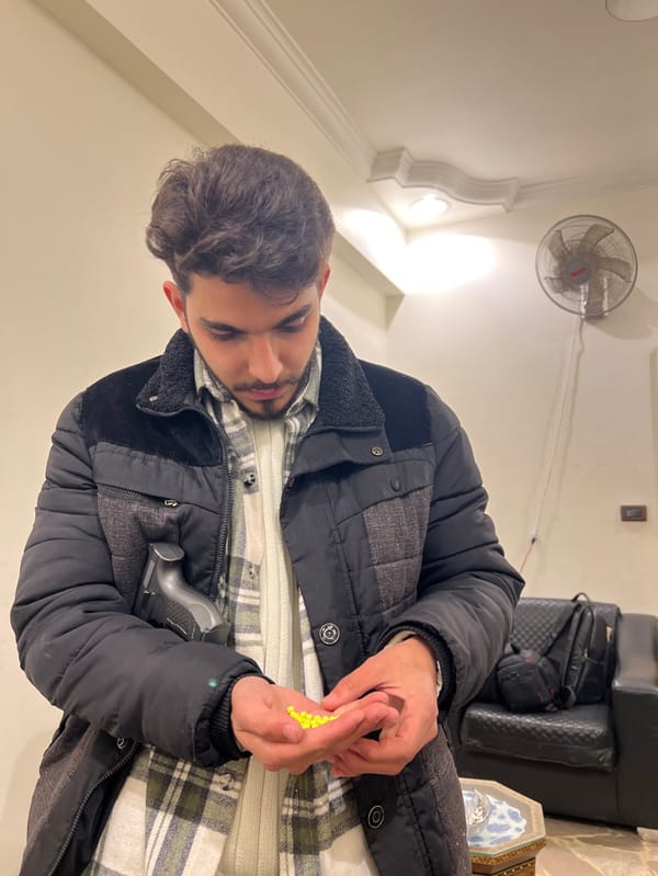 Man plays with toy guns in Damascus office