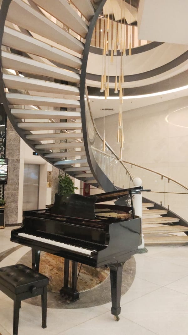 Grand piano spotted near spiral staircase in Vietnam ward