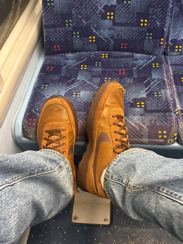 Train passenger in Nike shoes documented on London transit