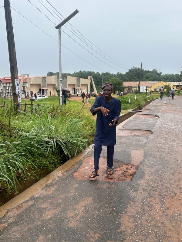 Pothole-riddled street scene in rainy Ogbomosho, Nigeria