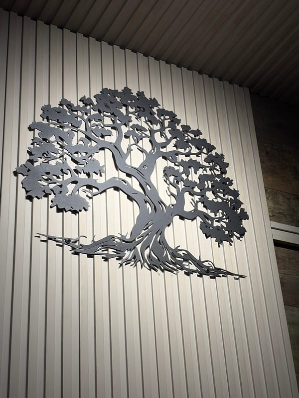 Dinner setting with wall art documented at unknown location