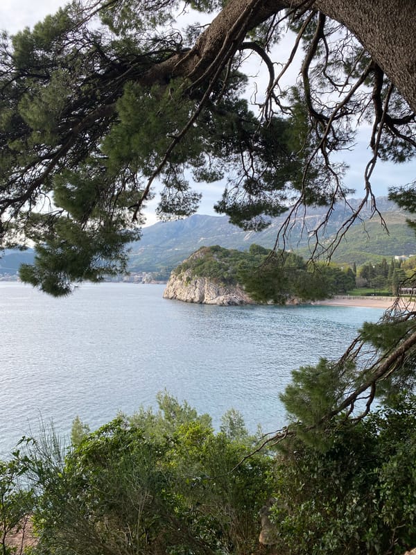 Tourist documents scenic views of Sveti Stefan resort Montenegro
