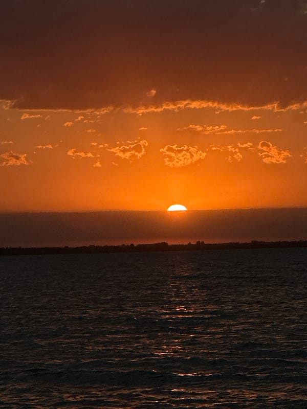 Warm sunset light spreads across a Kazakh lakeshore