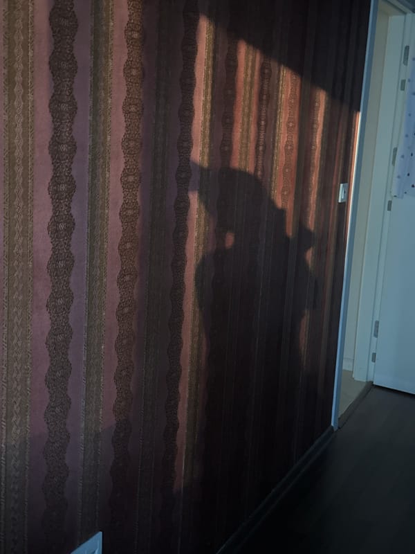 Child rests with phone on bed in Esenyurt home