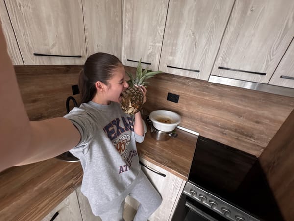 Woman holds pineapple in Bulgarian kitchen