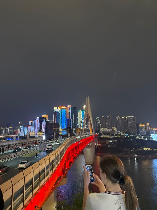Pedestrians gather at Hongyadong bridge amid city traffic flow