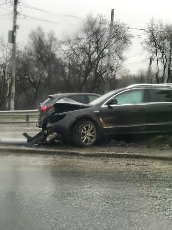 Damaged vehicle with rear-end impact observed roadside in Perm
