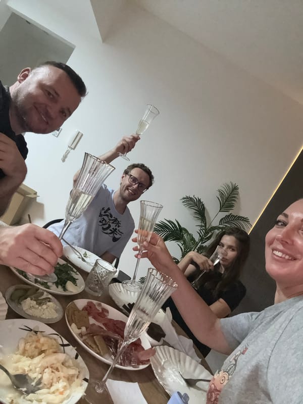 Group celebrates with champagne and charcuterie spread in Dubai
